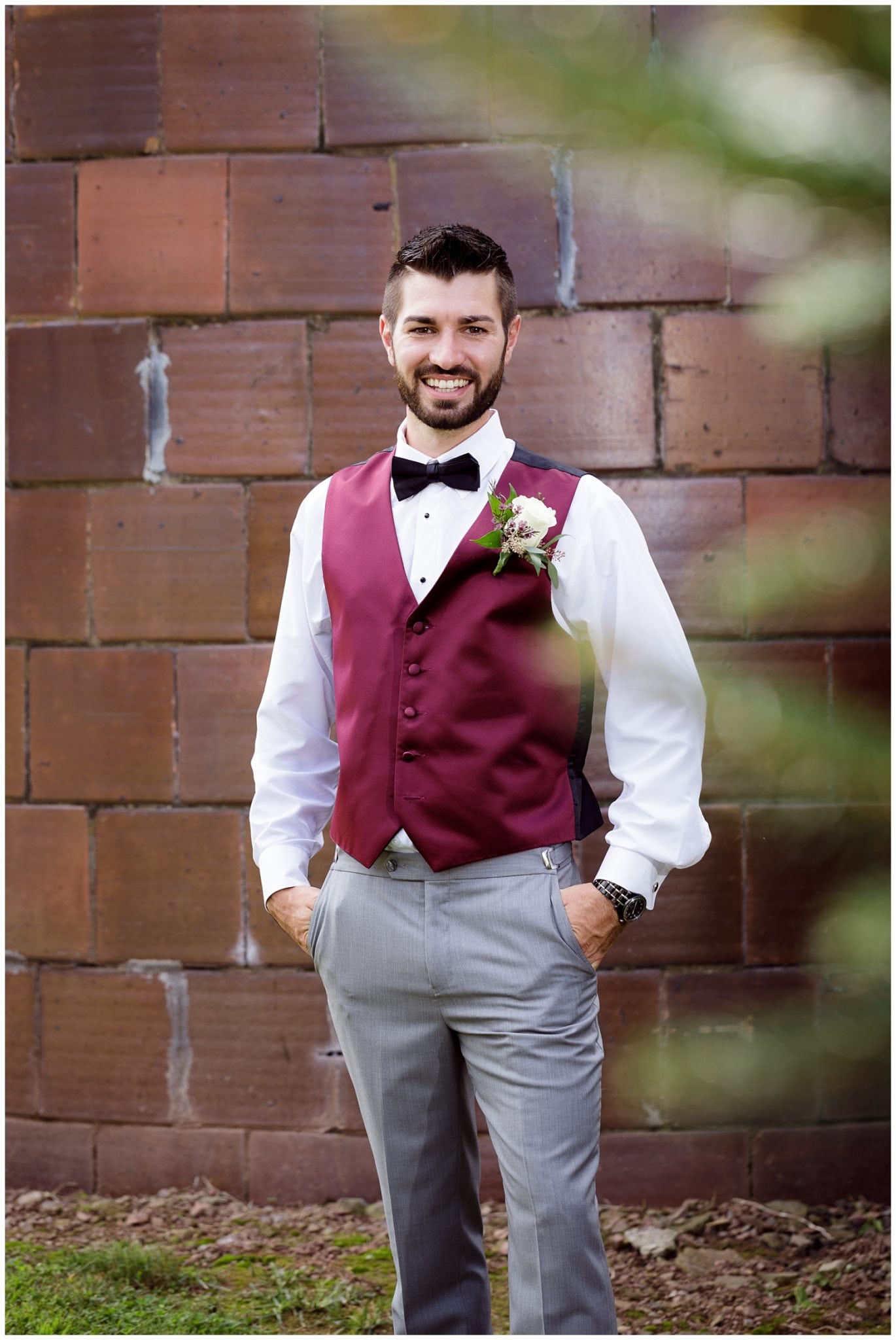 groom with burgundy vest