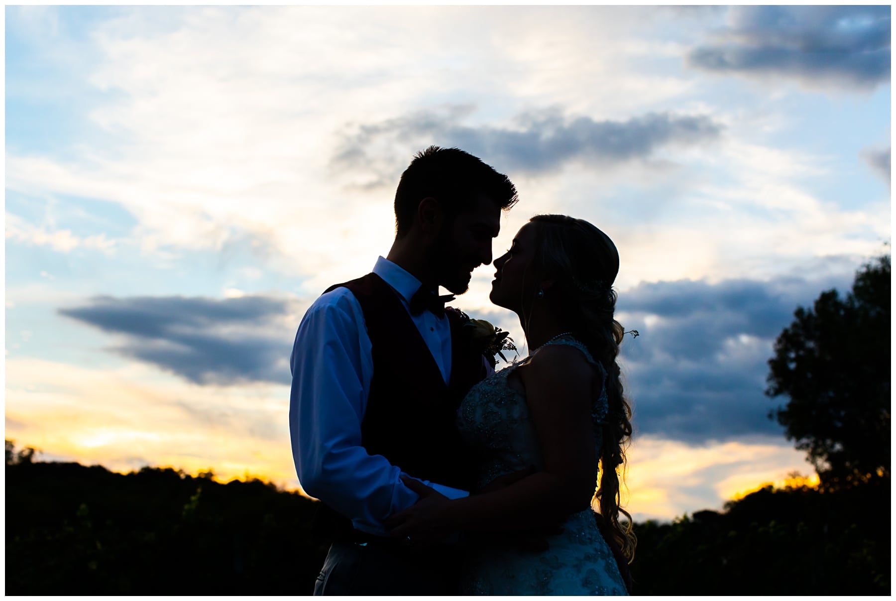 sunset silhouette of bride and groom